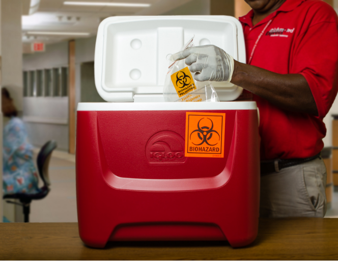 A Richmond Express employee puts biohazard material into a cooler