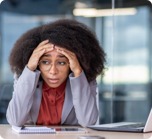 A woman looking stressed holds her forehead in frustration